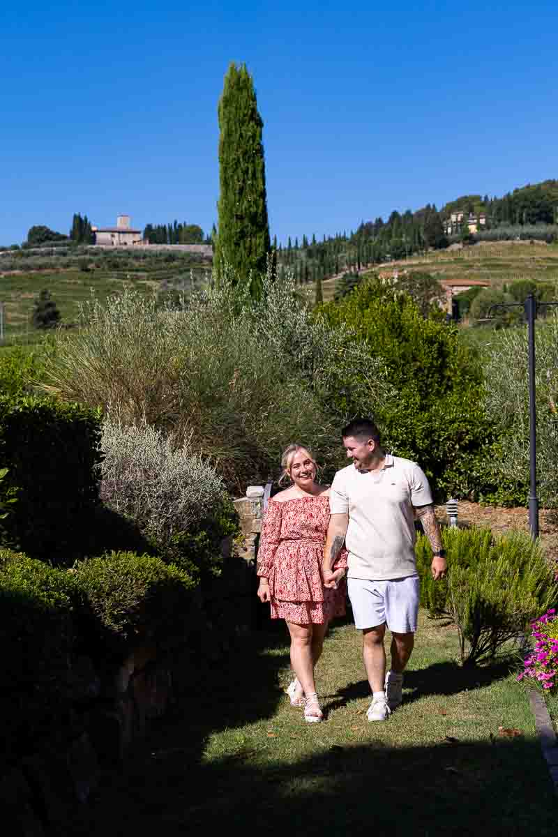 Walking together during a tuscany photo shoot in the countryside of a typical winery 