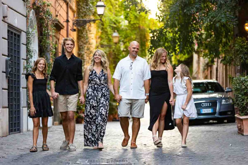 Walking in Rome Family photo session in the cobblestone alleyway streets with nice ivy leaves in the background