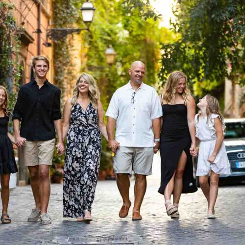 Walking in Rome Family photo session in the cobblestone alleyway streets with nice ivy leaves in the background