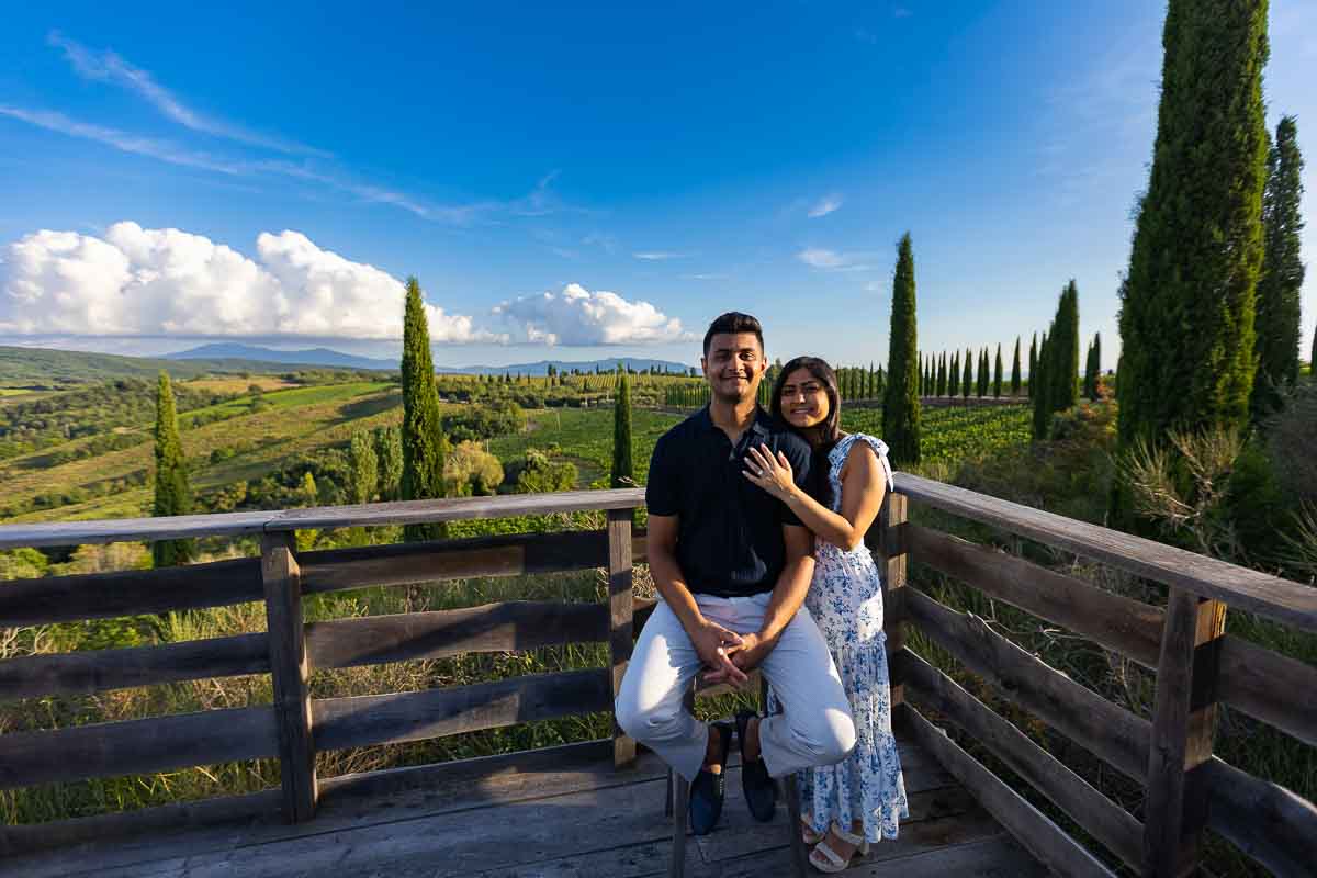 Posed portrait picture taken on a stool before the scenic view of the Tuscan countryside 