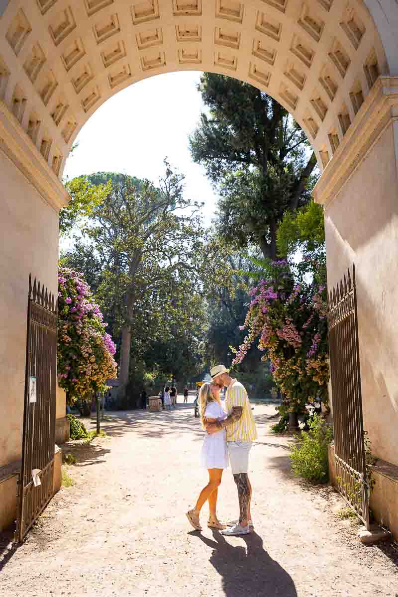 Standing under one of the entrances of the Villa Borghese lake in Rome Italy