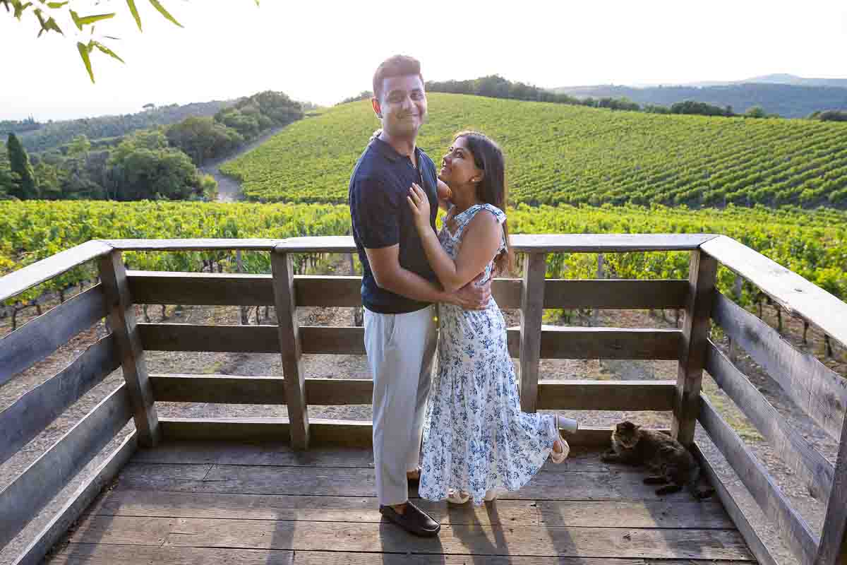 Couple taking pictures just engaged after a romantic proposal in Tuscany 