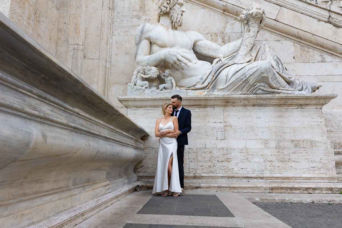 Posing for a marriage picture of a couple just married in Rome at Campidoglio 