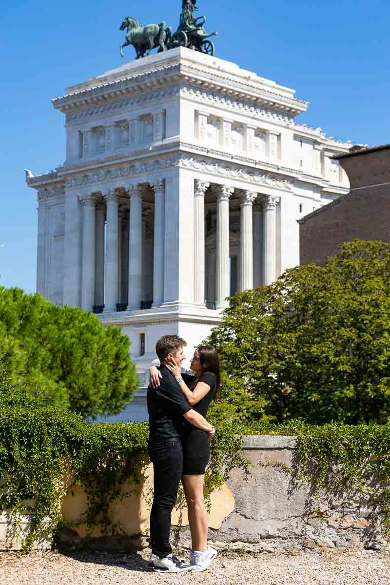 Sideway couple portrait photographed with the Vittoriano monument in the background