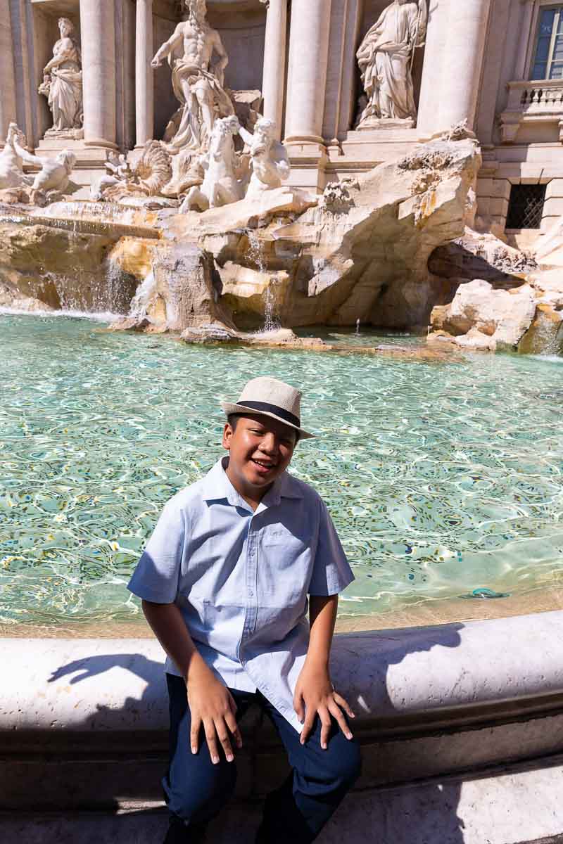 Son solo shot photographed while sitting on the edge of the Trevi fountain in Rome Italy
