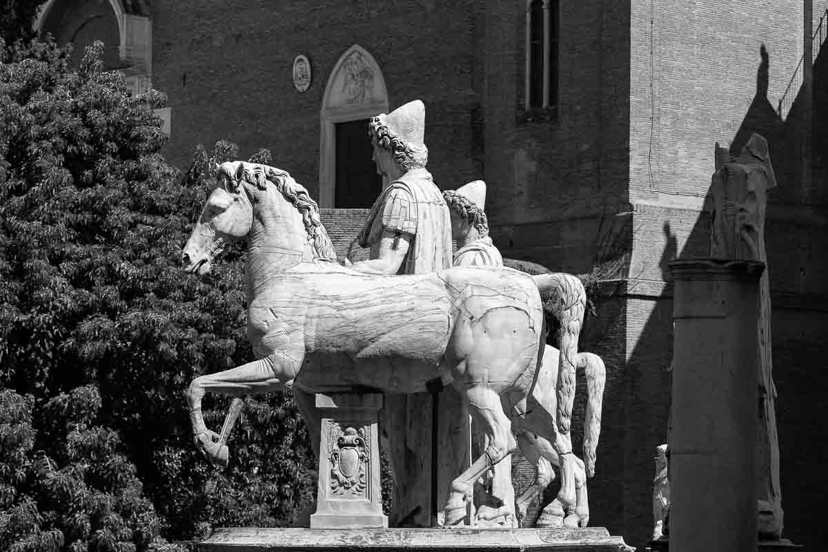 Black and white photography of the huge marble horses found in Piazza del Campidoglio 