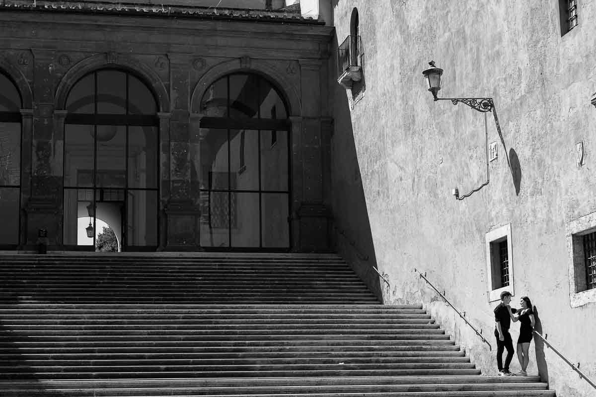 Artistic shot taken of a couple standing on a large staircase during a photography session in Rome 