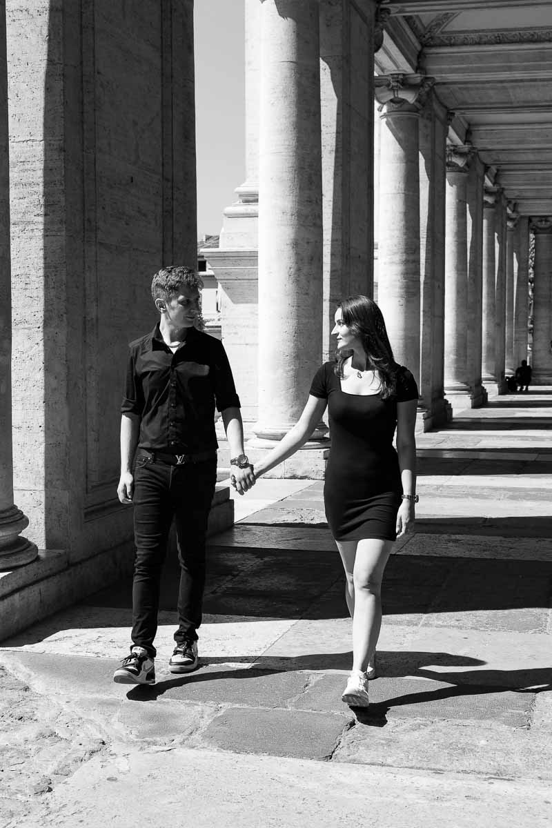 Walking together underneath ancient roman columns 