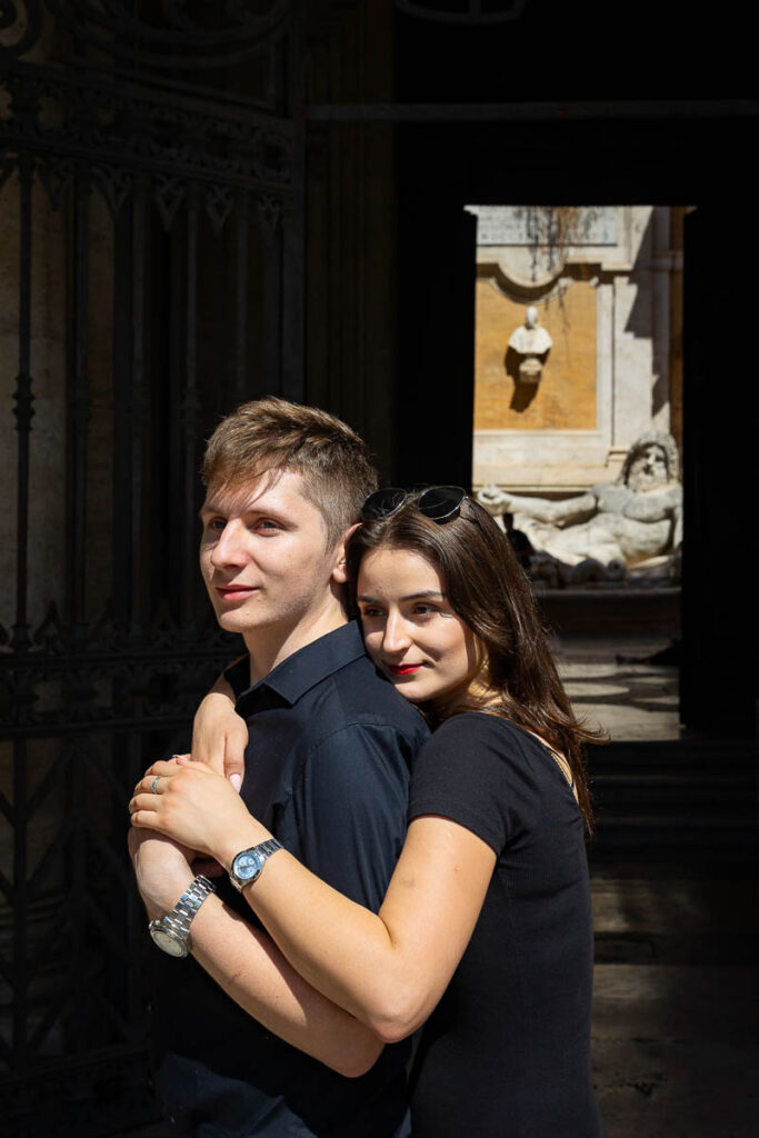 Engagement portrait shot before an ancient roman statue