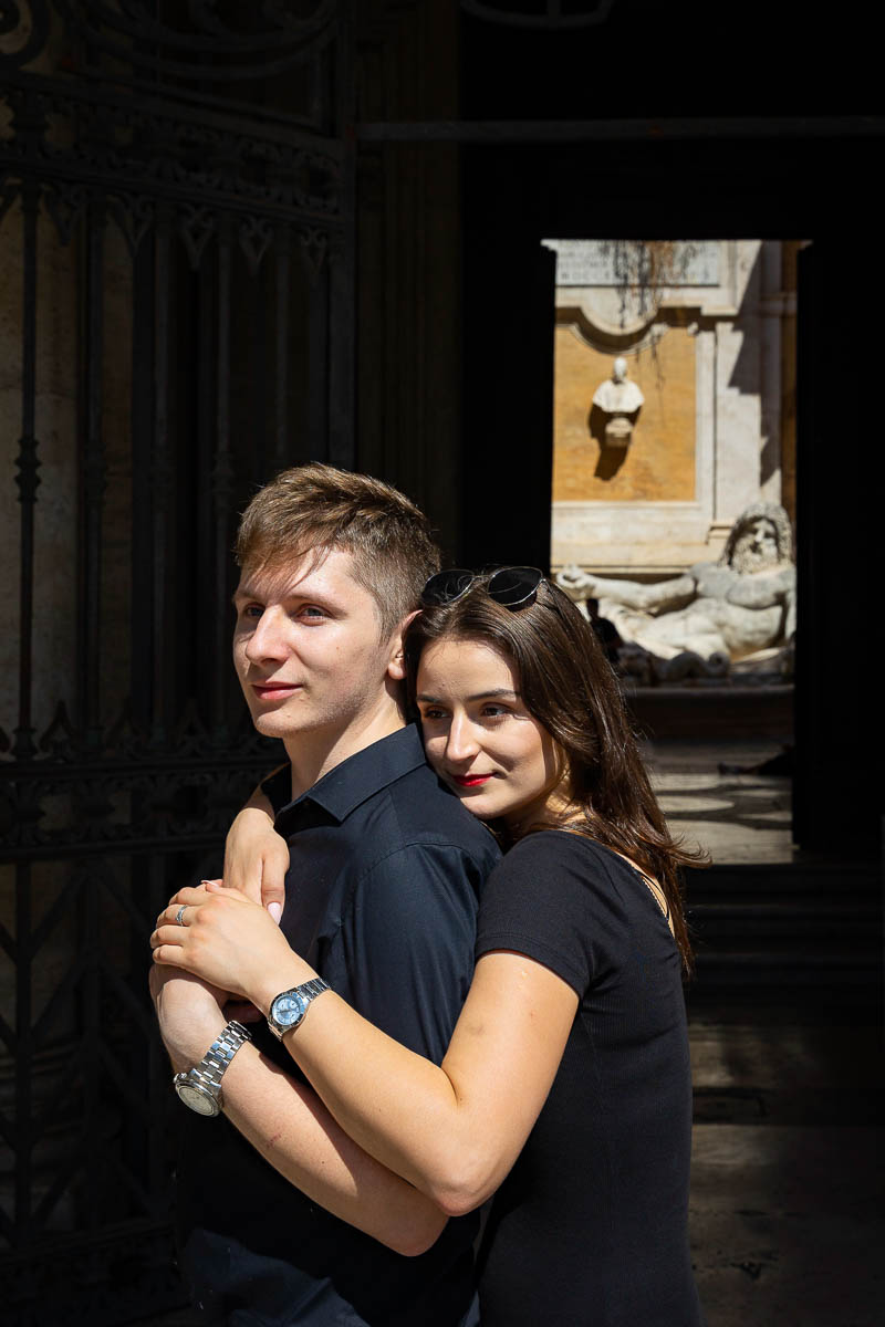 Engagement portrait shot before an ancient roman statue 