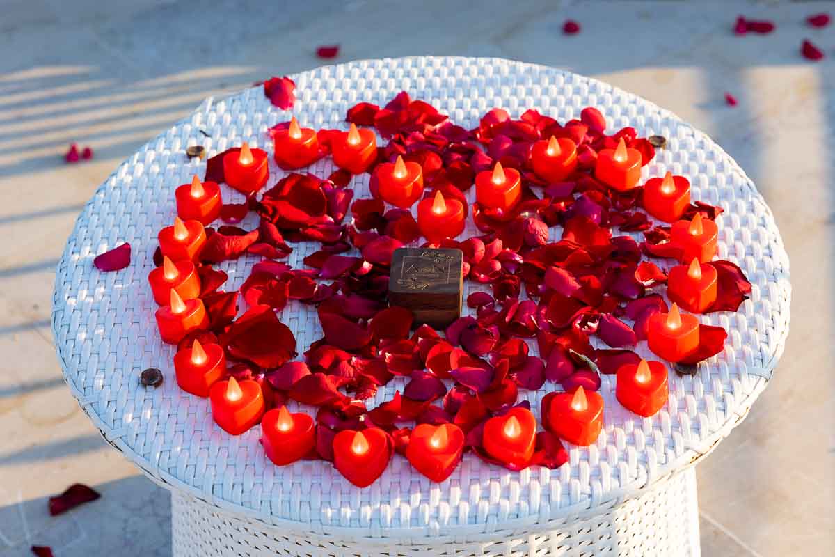 Proposal in Sorrento. Table embellished with red heart shaped candles and red rose petals 