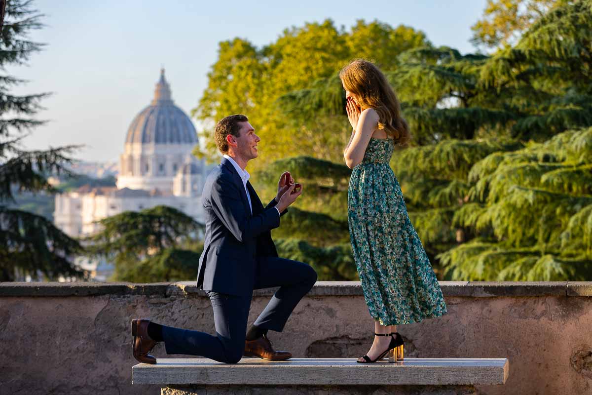 Proposing before the view of Saint Peter's cathedral dome on the Janiculum hill during a photoshoot in Rome