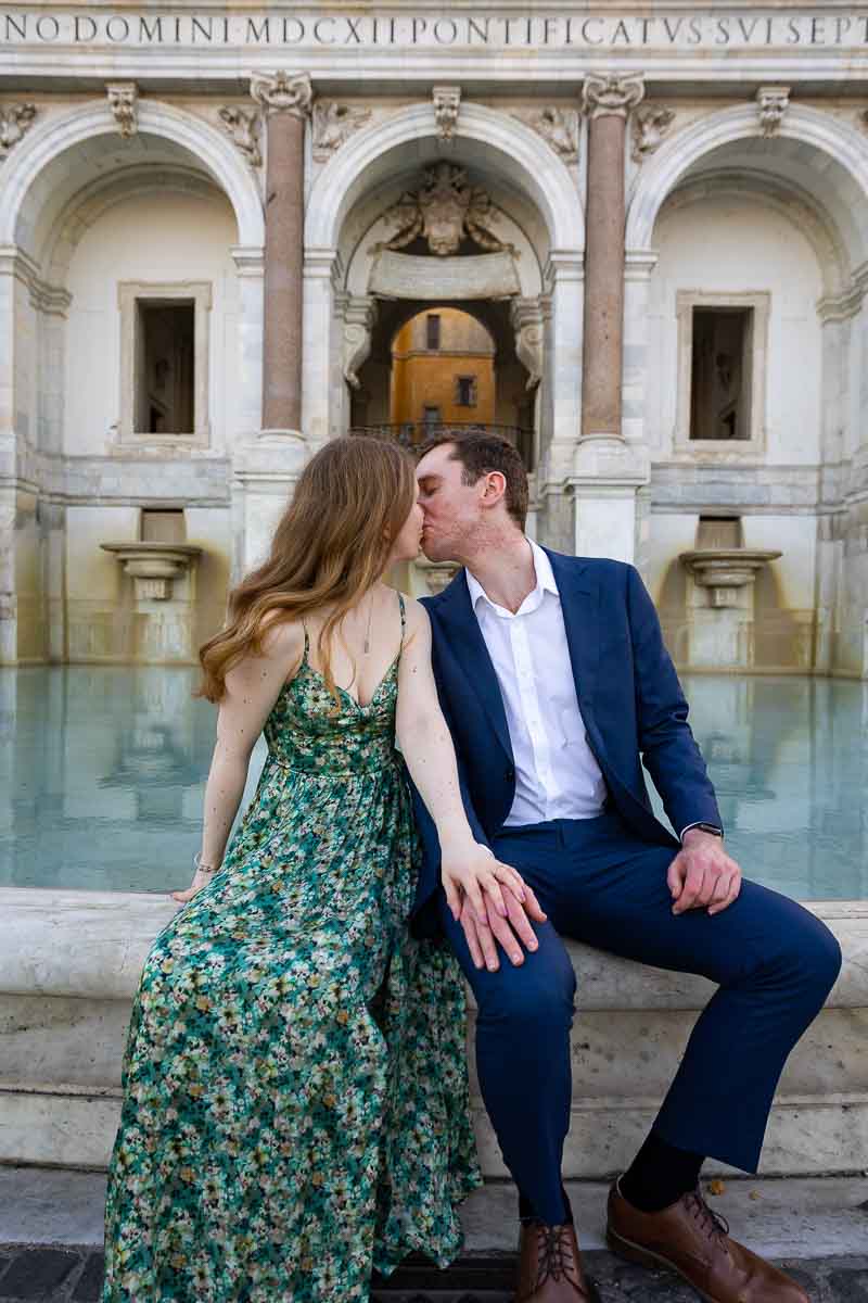 Sitting on the edge of water fountain taking couple portrait pictures 