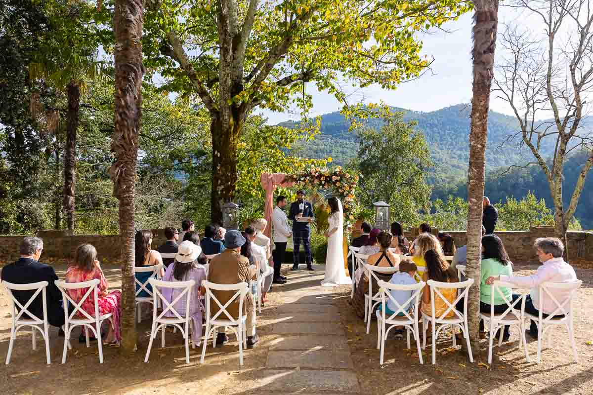 The outdoor Tuscany wedding ceremony with the bride and groom in a scenic tuscan villa