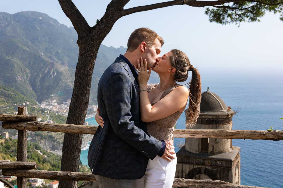 Kissing after a surprise wedding proposal in Ravello at Villa Rufolo 