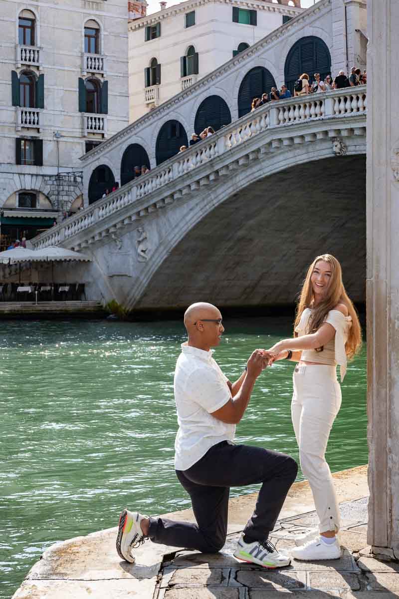 Joy and happiness after marriage proposal at the Rialto bridge in Venice Italy