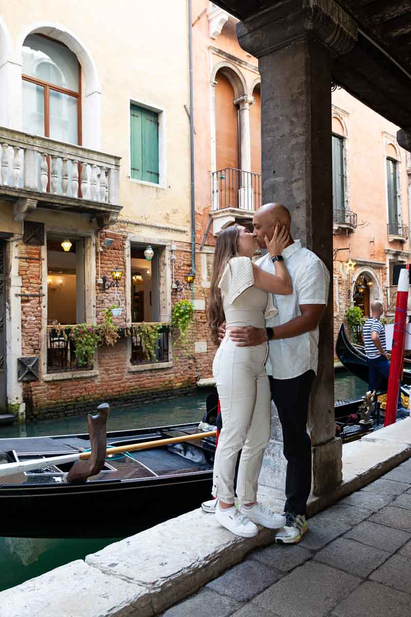 Kissing portrait of just engaged couple in Venice Italy