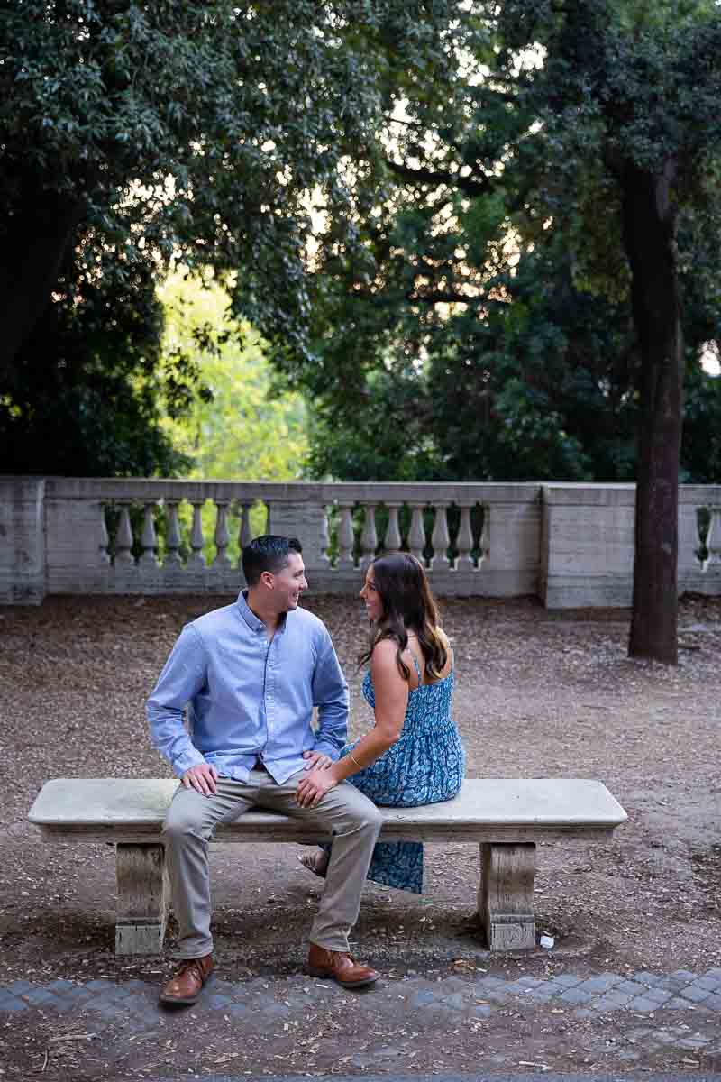 Sitting on a marble bench taking just engaged photos 