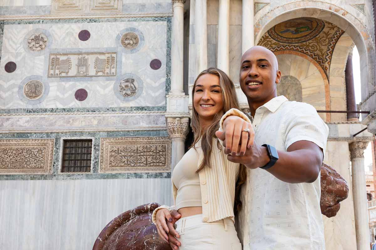 showing off the engagement ring during a couple photo shoot 