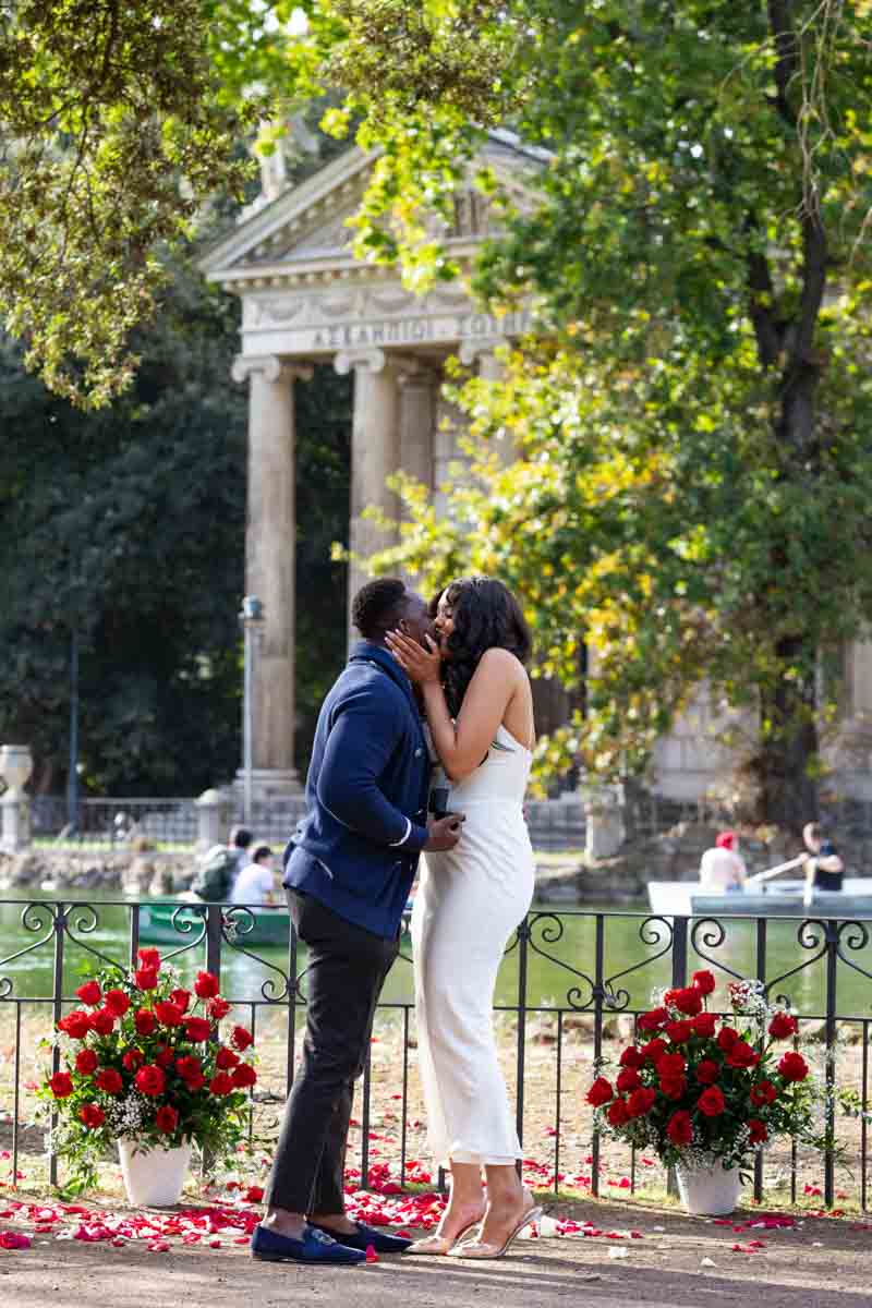 She said yes moment to a romantic wedding marriage proposal photographed in Rome among beautiful red roses 