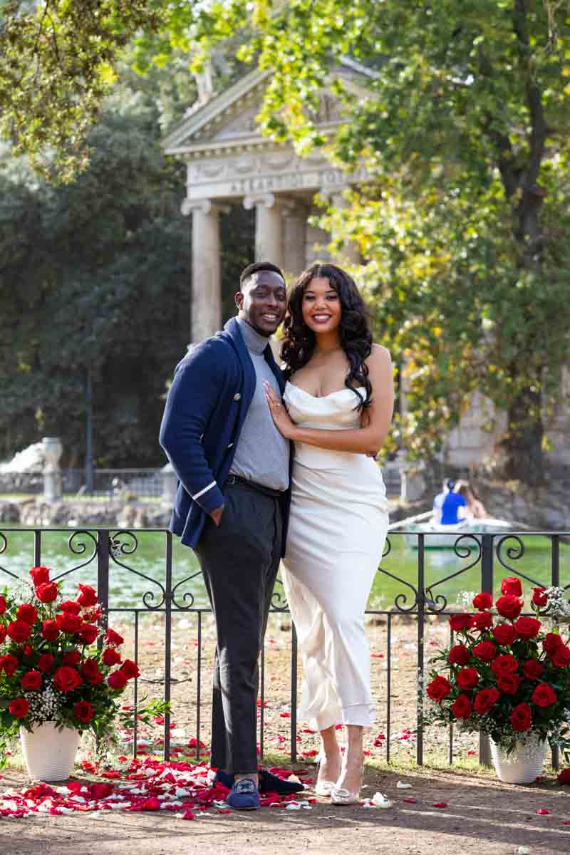 Posed couple portrait taken by the lakeside in Villa Borghese lake in Rome Italy