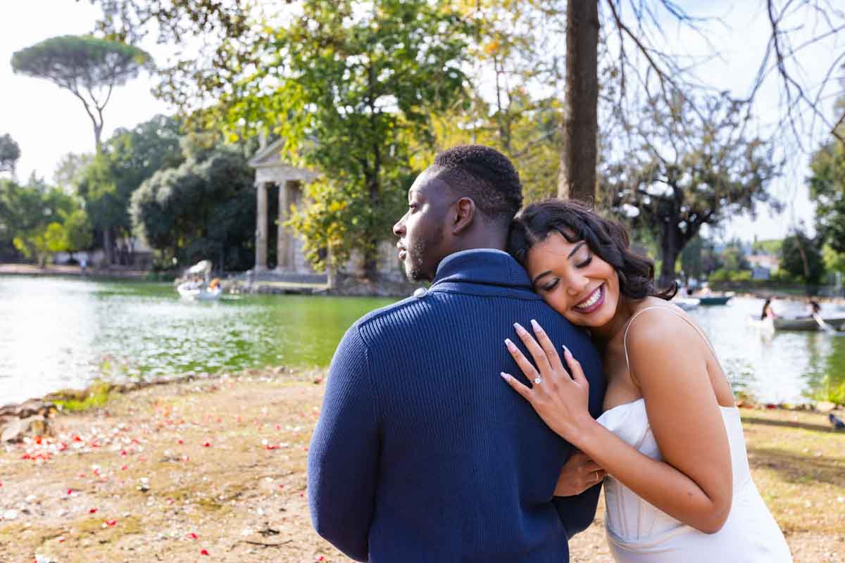 Couple portrait leaning on each other's shoulder while showing the beautiful engagement ring