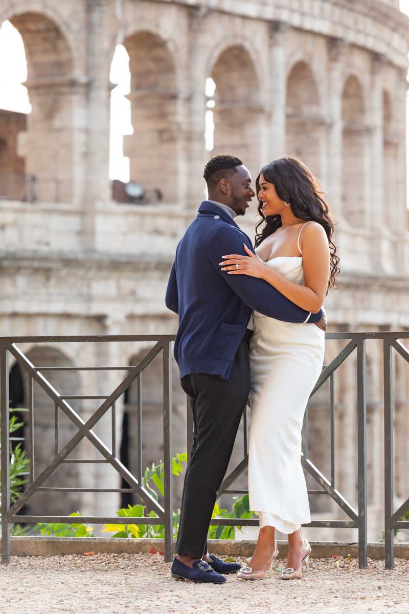 Standing close together while taking pictures together at the Coliseum