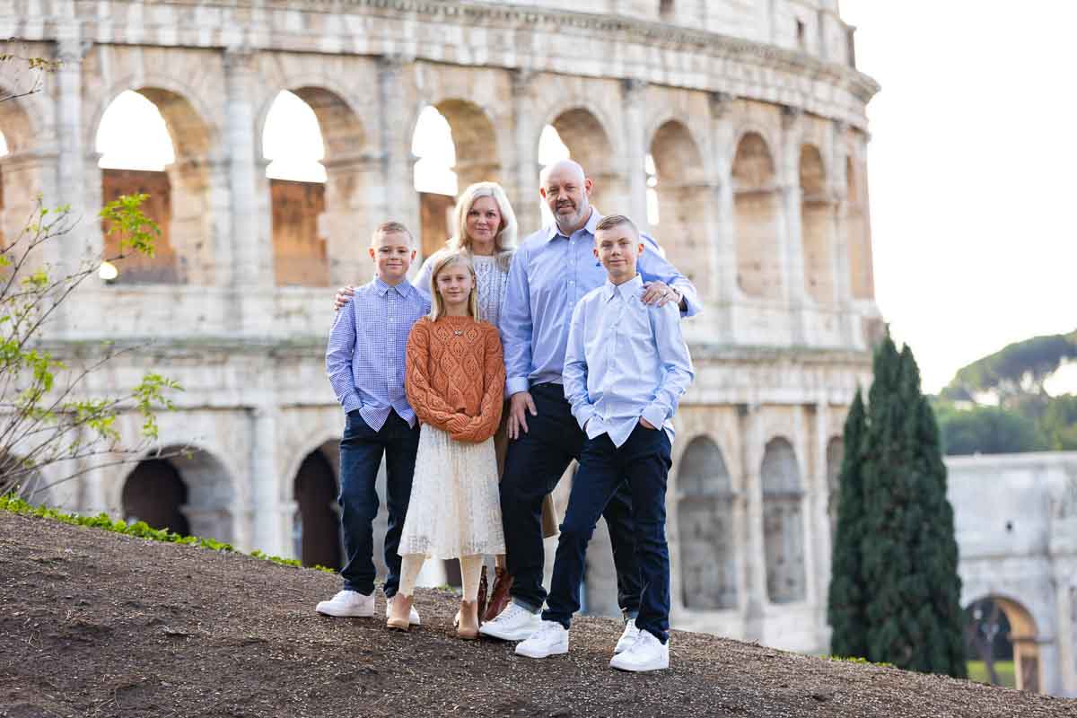 Family photoshoot in Rome posing in front of the Roman Colosseum