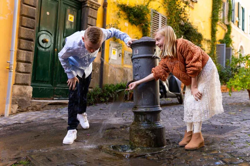 Having fun with a water fountain during a photo shoot in Rome Italy