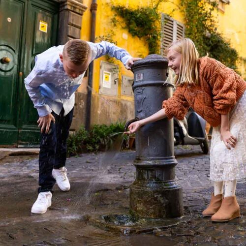 Having fun with a water fountain during a photo shoot in Rome Italy