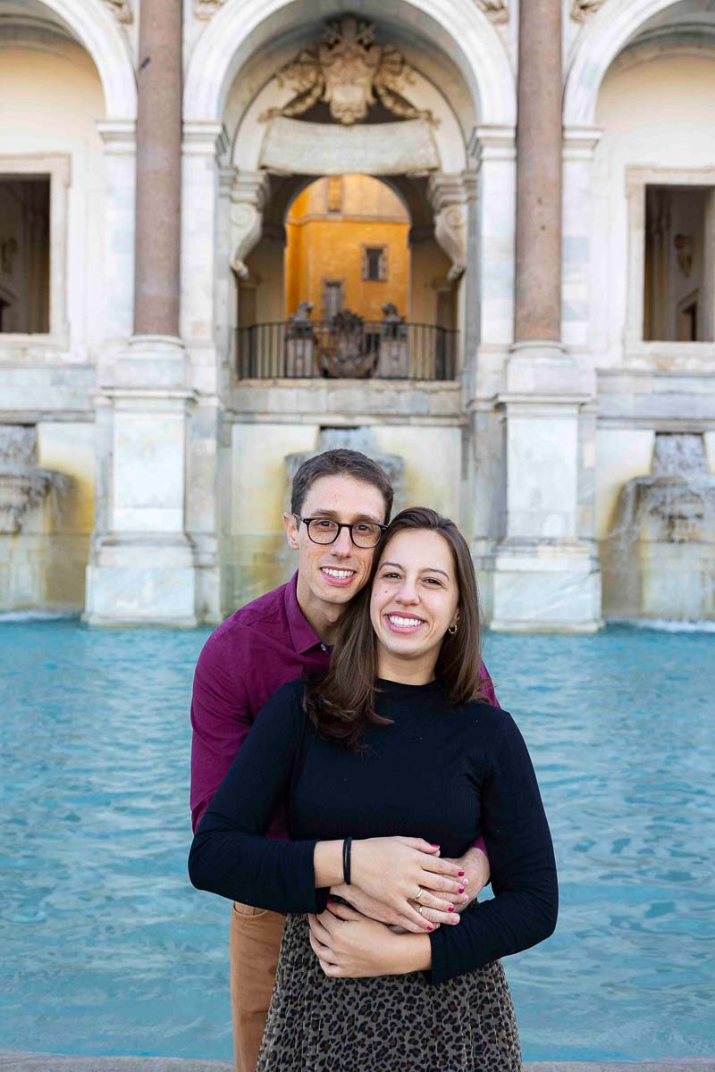 Portrait picture of a couple taken during a photography session in Rome by the Fontanone water fountain in Italy. Proposing on the Janiculum hill