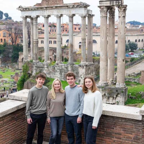 Family portrait pictures taken at the Roman Forum posing down in front of the ancient temples and monuments