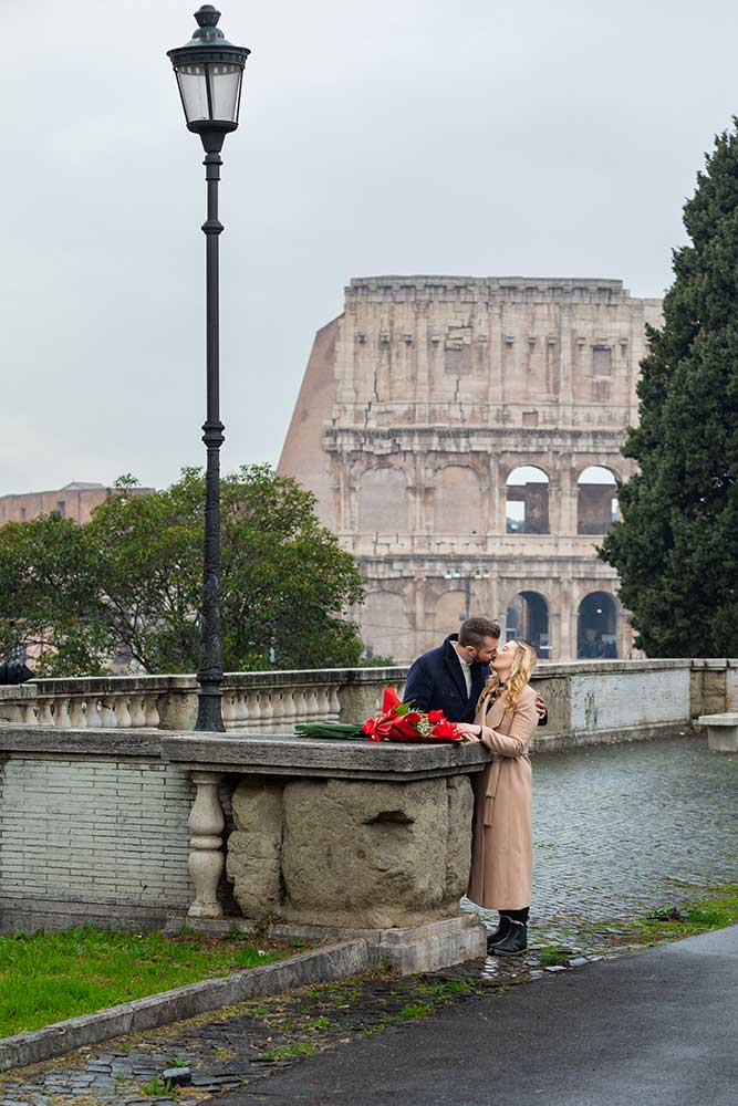 In Love in Rome photoshoot story standing underneath a light pole with the Coliseum as background. Colosseum view proposal