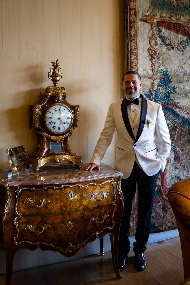 Bride portrait photography while standing to an ancient clock found in the hotel hall 