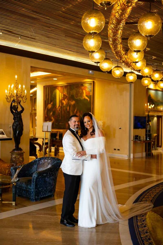 Bride and groom reunited in the wedding gown and suit taking a portrait picture together in a luxurious hotel in Rome Italy
