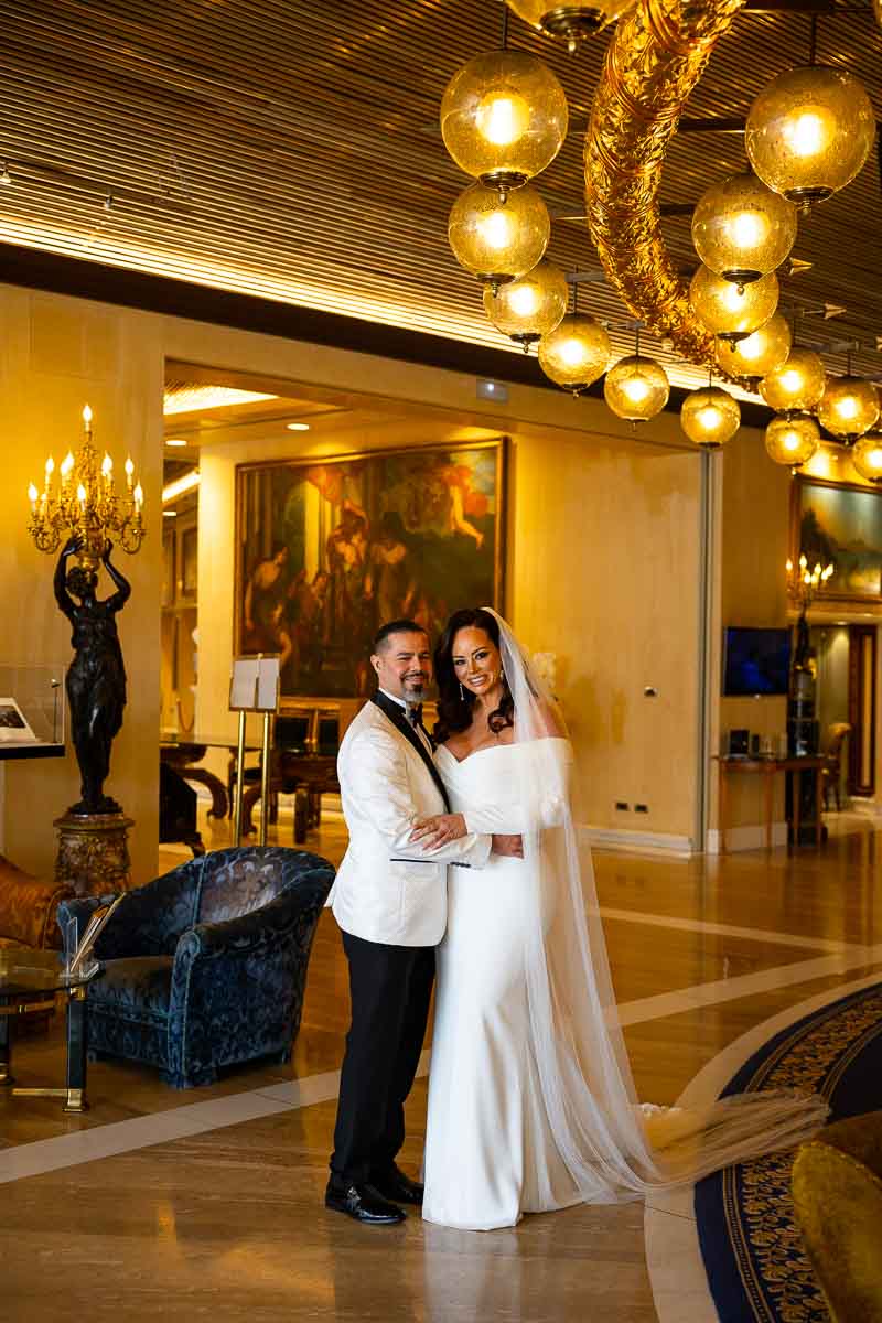 Bride and groom reunited in the wedding gown and suit taking a portrait picture together in a luxurious hotel in Rome Italy 