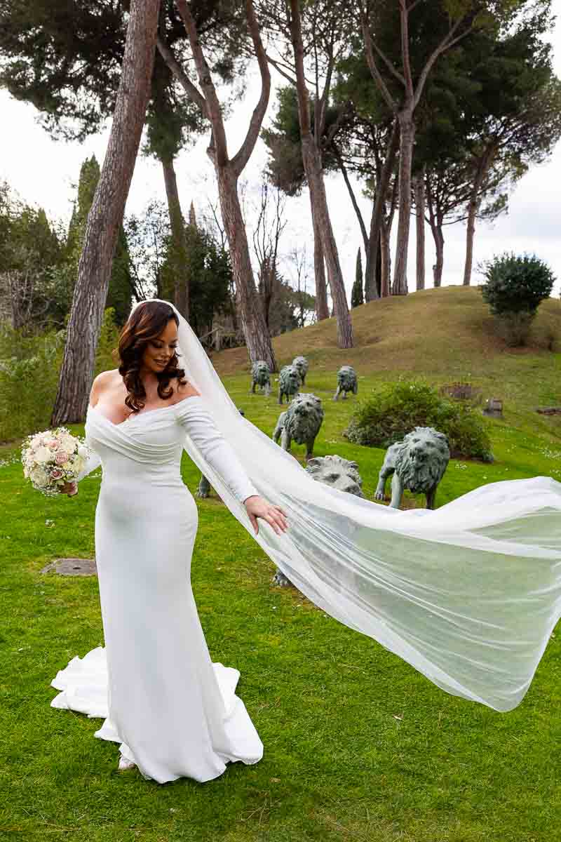 Bride letting her veil flow in the air while taking wedding photography in Rome Italy