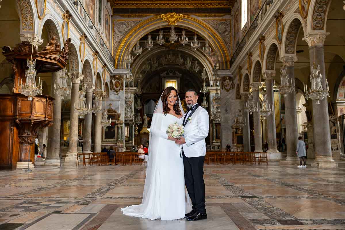 Just married in Rome and taking wedding photos together in a Roman church
