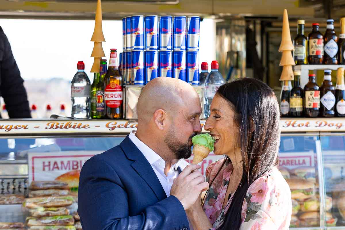 Eating an ice cream together during a surprise engagement photo shoot in Rome 