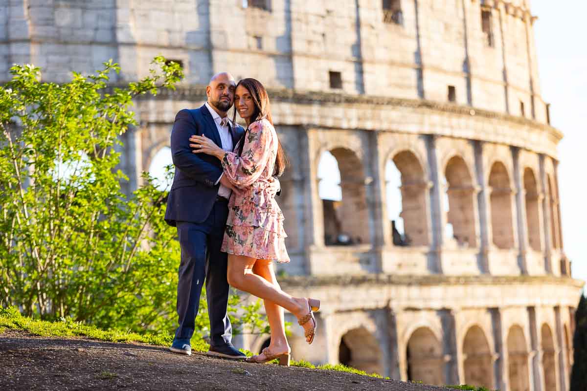 Standing together on a small hill that overlooks the Colosseum from afar