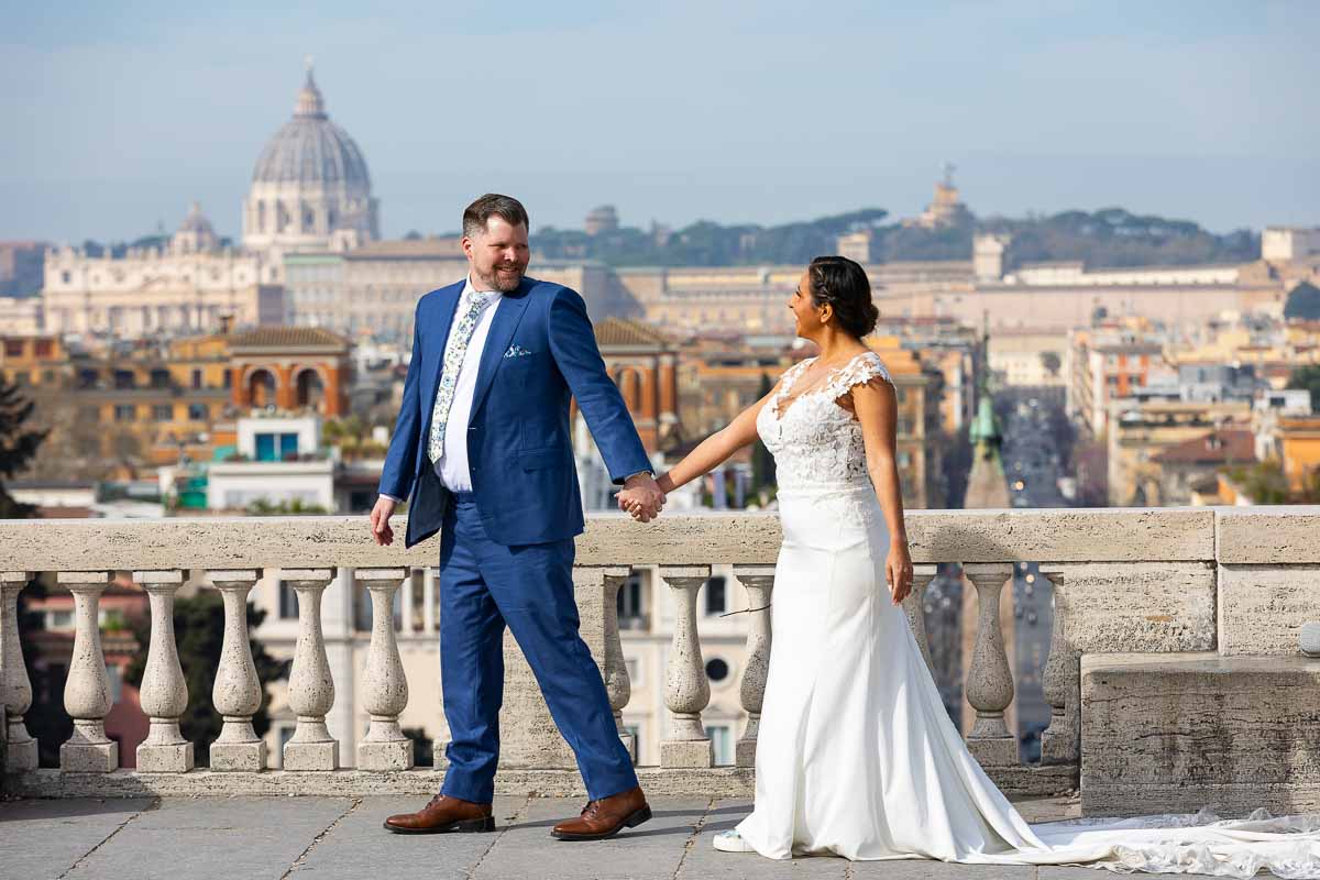 Just married in Rome and taking a walk during their photographer session overlooking the city from the Pincio park terrace 