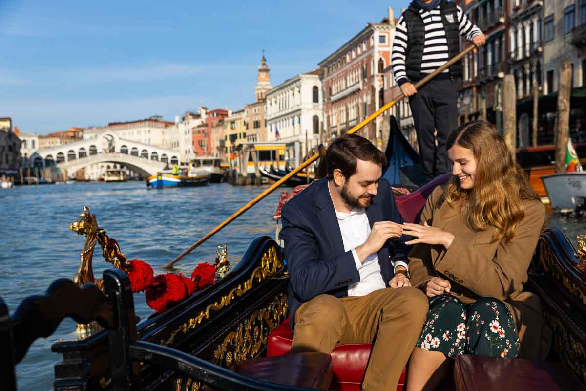 Placing the engagement ring on the finger during a gondola proposal