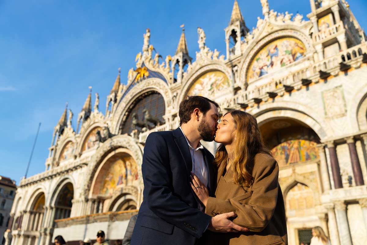 Couple kissing in front of Palazzo Ducale in the center of Venice Saint Mark's place