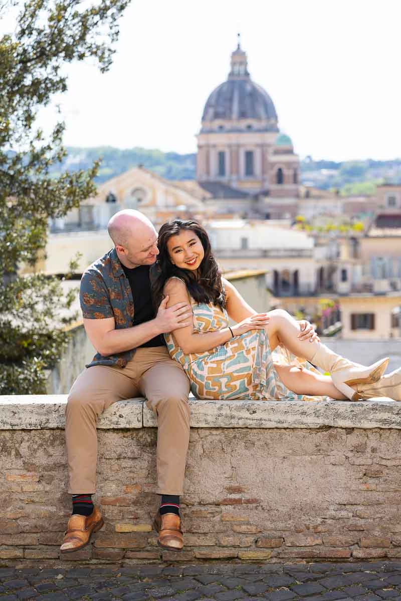Together in Rome engagement photos while posing in front of the Roman rooftops