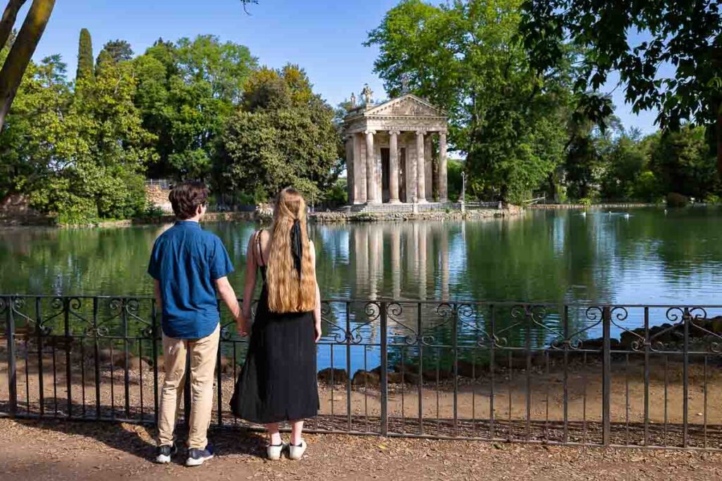 Admiring Temple of of Asclepius found on the edge of the Villa Borghese lake during an engagement photography session