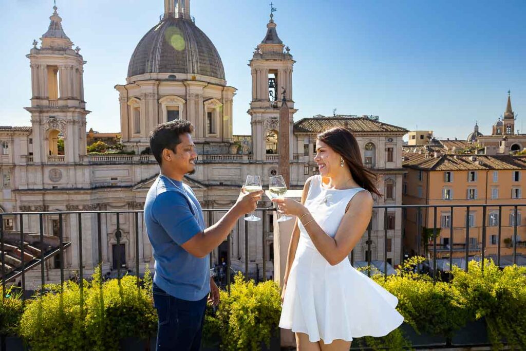 Toasting with the engagement photos under a blue bright sky