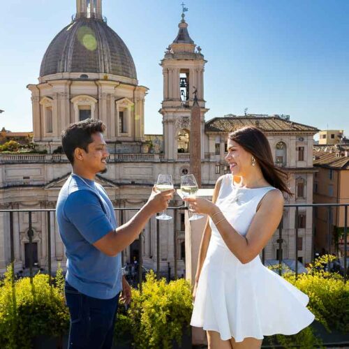 Toasting with the engagement photos under a blue bright sky