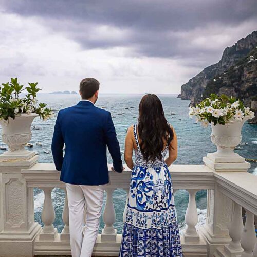 Couple admiring the mediterranean sea from a hotel balcony during a photography session on the Amalfi coast