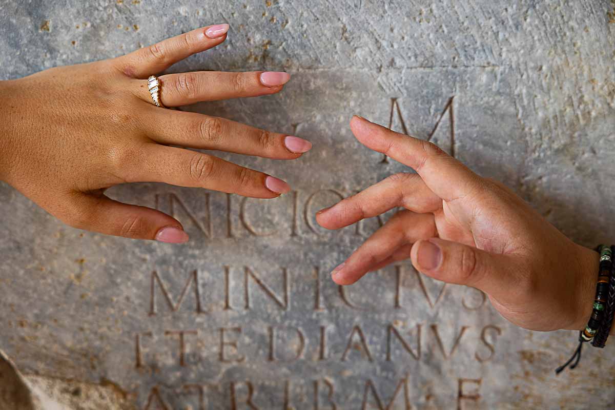Engagement ring close up image with fingers reaching out for each other 