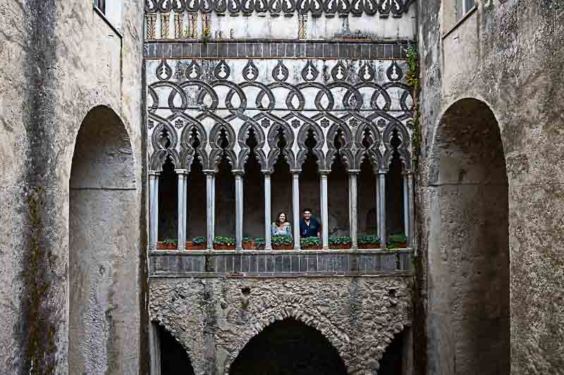 Final portrait image of them standing next to each other underneath the typical columns found in Villa Cimbrone 